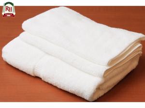a stack of white towels sitting on a table at Richmond Hotel Tokyo Shiba in Tokyo