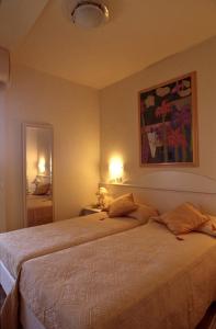 a bedroom with a large bed with two pillows at Residence Darsena in Cattolica