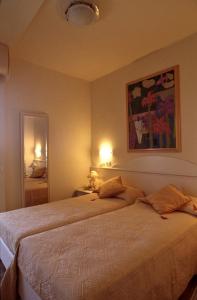 a bedroom with a large bed with two pillows at Residence Darsena in Cattolica +50 photos