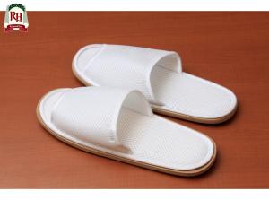 a pair of white shoes on a wooden table at Richmond Hotel Tokyo Shiba in Tokyo