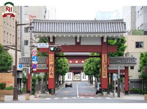 a red bridge over a street in a city at Richmond Hotel Tokyo Shiba in Tokyo