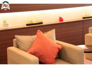 a chair with a red pillow in a room at Richmond Hotel Tokyo Shiba in Tokyo