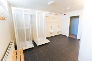 a room with three white vases on the wall at Lofotr Overnatting in B&oslash;stad