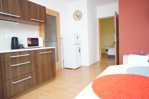 a kitchen with a white refrigerator in a room at Apartmá Kateřina Velké Losiny in Velké Losiny