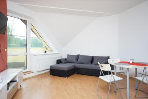 a living room with a couch and a table at Apartmá Kateřina Velké Losiny in Velké Losiny