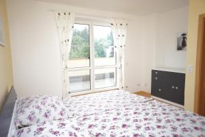 a bedroom with a bed and a window at Apartmá Kateřina Velké Losiny in Velké Losiny