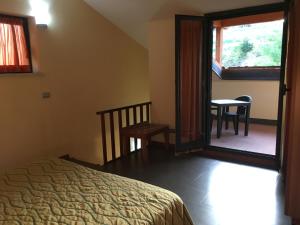 Postel nebo postele na pokoji v ubytování Hotel Langhe & Monferrato