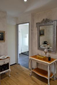 a living room with a table and a mirror at La Ferme Pateli in Courouvre +24 photos