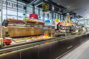 a restaurant kitchen with a buffet of food at Serways Hotel Steigerwald in Wachenroth