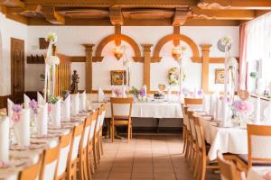 a row of tables in a room with white tablecloths at Gasthof zur Sonne Winzenhohl in Hösbach