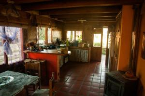 a kitchen with a counter and a table in it at Wayra Waka in Villa Giardino