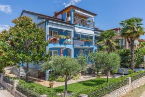 a blue house with trees in front of it at Villa Tina Porec in Poreč
