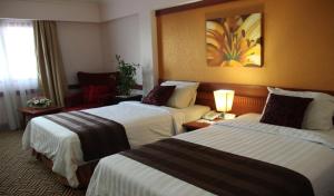 Voodi või voodid majutusasutuse Abadi Suite Hotel & Tower toas