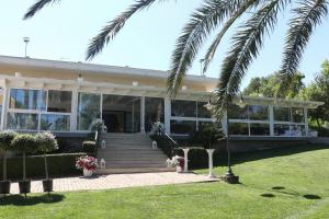 a house with a palm tree in front of it at Le camere di Villa Incanto in Colonnella