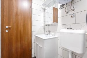a white bathroom with a toilet and a sink at Apartment Irene in Poreč +25 photos