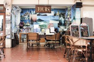 a restaurant with chairs and a table in a store at Lamphuhouse Bangkok in Bangkok