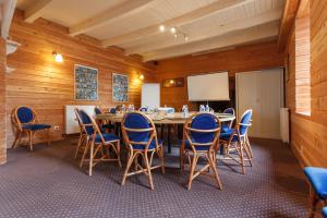 una sala de conferencias con mesa y sillas en Auberge Du Cheval Blanc, en Baud