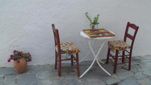 a small table and two chairs next to a table at Creta Vassakis Studios in Kefalos
