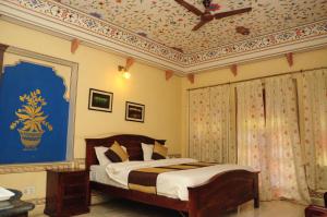 A bed or beds in a room at Sajjan Niwas