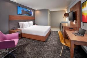 A bed or beds in a room at Studio Inn & Suites at Promenade Downey