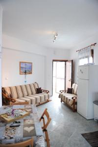 a living room with a couch and a table at Dafni's Home 50 meters from the beach in Yerakiní