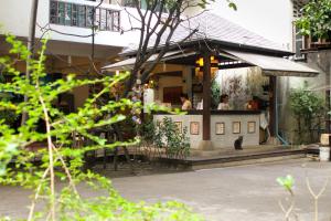 a restaurant with a cat sitting in front of it at Lamphuhouse Bangkok - SHA Extra Plus Certified in Bangkok