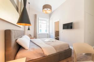 Postel nebo postele na pokoji v ubytování Guest Roma House