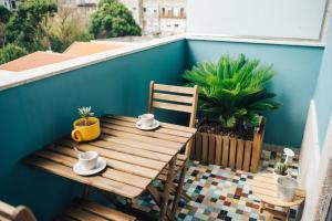 a wooden table and chairs on a balcony at Wood Loft by RDC in Porto