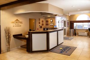 a lobby of a muncie medical center with a counter at Microtel Inn & Suites by Wyndham St Clairsville - Wheeling in Saint Clairsville