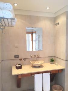 a bathroom with a sink and a mirror at Hosteria Los Hielos in El Calafate