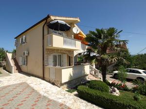 a large house with an umbrella on top of it at Apartments Barbara in Banj