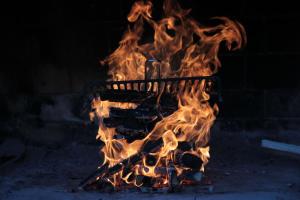 a fire grill with flames coming out of it at Apartments Irina in Rovanjska