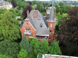 an aerial view of a large house with a turret at Business Apartment Briller Viertel in Wuppertal