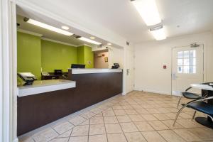an office with a reception desk and green walls at Studio 6 Extended Stay - Duluth, GA - Atlanta - Gwinnett Place in Duluth +38 photos