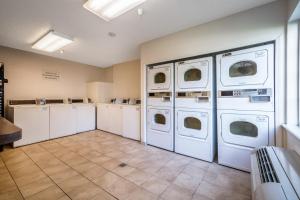 a laundry room with four washer and dryers at Studio 6 Extended Stay - Duluth, GA - Atlanta - Gwinnett Place in Duluth