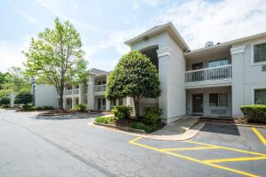 a large white building with a parking lot at Studio 6-Duluth, GA - Atlanta - Gwinnett Place in Duluth