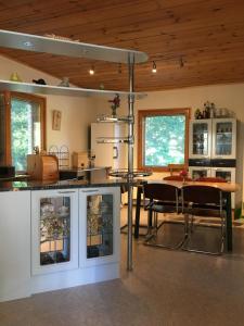 a kitchen with a table and chairs in a room at Konnaoja Holiday Home in Taterma