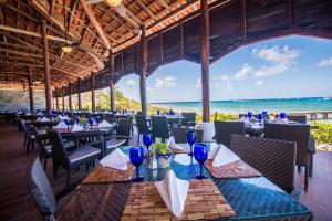 a restaurant on the beach with tables and chairs at Occidental Cozumel - All Inclusive in Cozumel