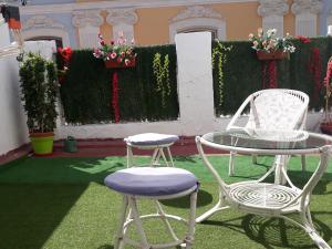 two chairs and a table and a table and chairs at Hostal Mayor in Alicante