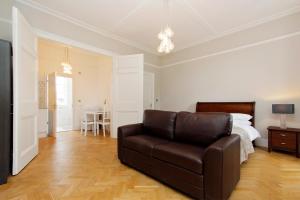 a living room with a couch and a bed at Apartments At Marylebone in London