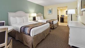 a hotel room with two beds and a television at Best Western Gateway To The Keys - Florida City, Homestead, Everglades in Florida City