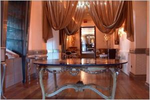 a large room with a table in the middle of a room at San Anselmo in Rome
