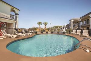 a large swimming pool with lounge chairs in a resort at Best Western Inn Florence in Florence