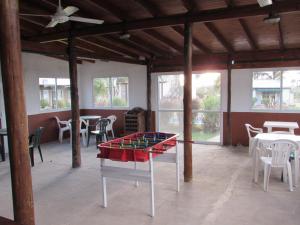 a ping pong table in a room with tables and chairs at Las Mentas in Victoria