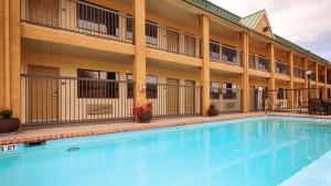 a large swimming pool in front of a hotel at Best Western Cedar Inn in Cedar Park