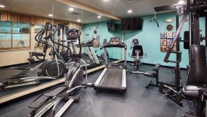 a gym with several tread machines in a room at Best Western Plus Monahans Inn and Suites in Monahans