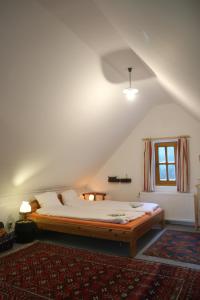 a bedroom with a large bed in a attic at Cottage by the woods in Balatonhenye