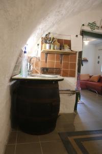 a kitchen with a counter on top of a barrel at Cottage by the woods in Balatonhenye