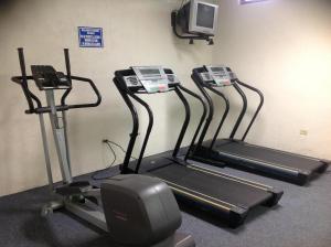 a gym with three tread machines and a tv at Best Western Hotel Plaza Matamoros in Matamoros
