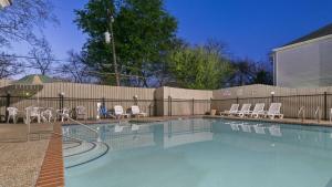 a swimming pool with chairs and a fence at Best Western San Marcos in San Marcos